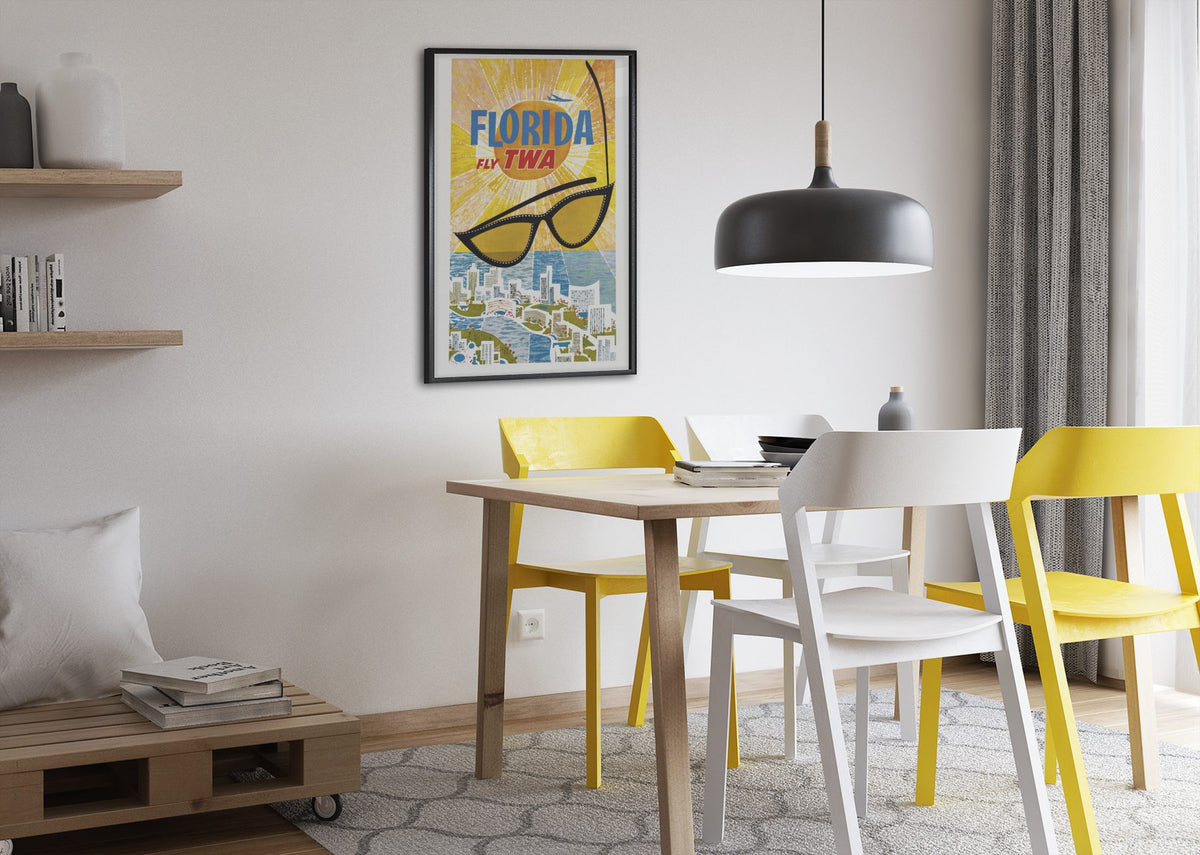 Florida Fly TWA poster framed above a dining table