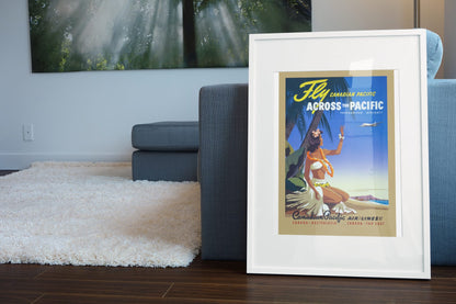 Fly Across the Pacific Canadian Pacific poster leaning beside a blue sofa