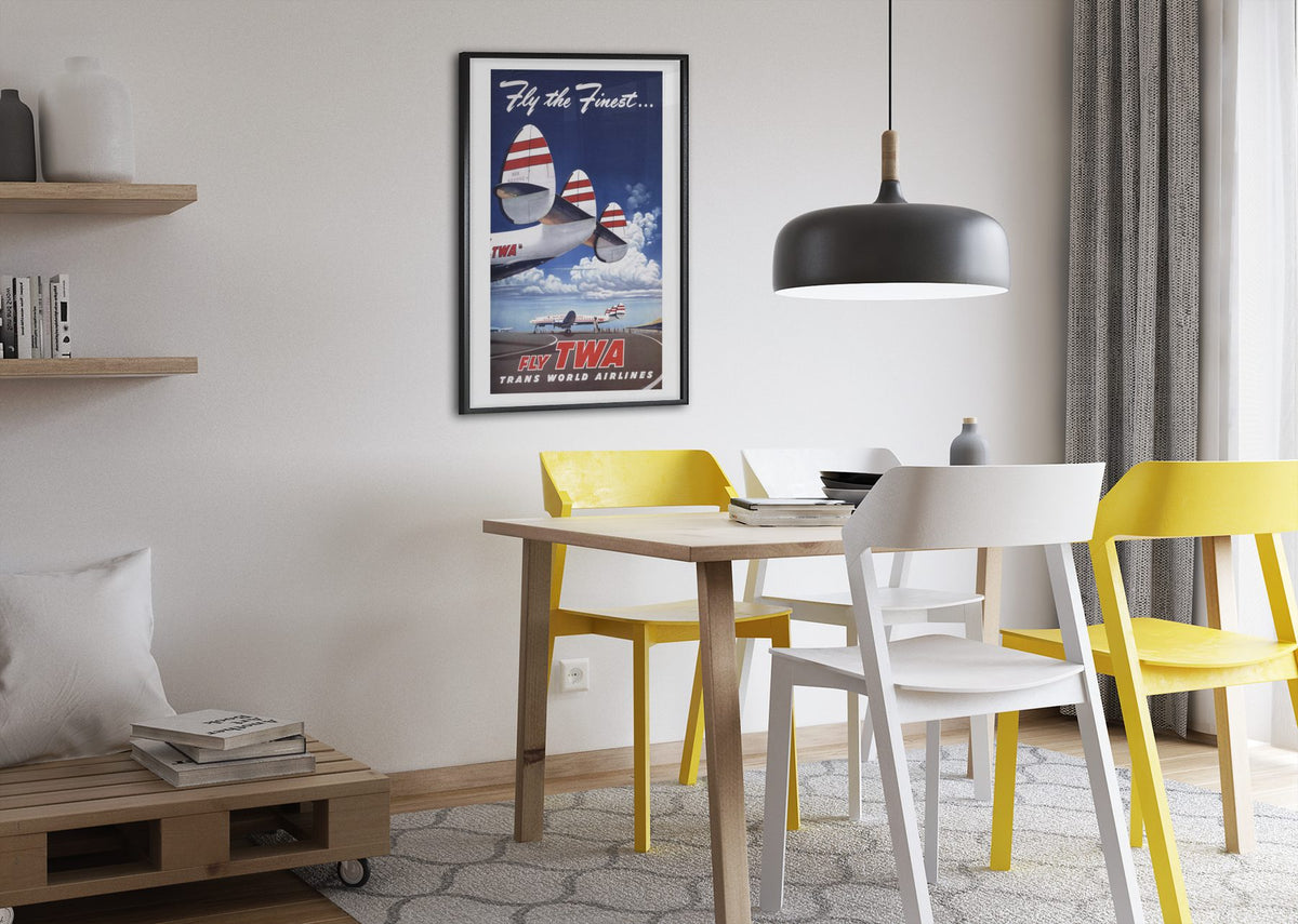 Fly the Finest Fly TWA poster framed above a dining table