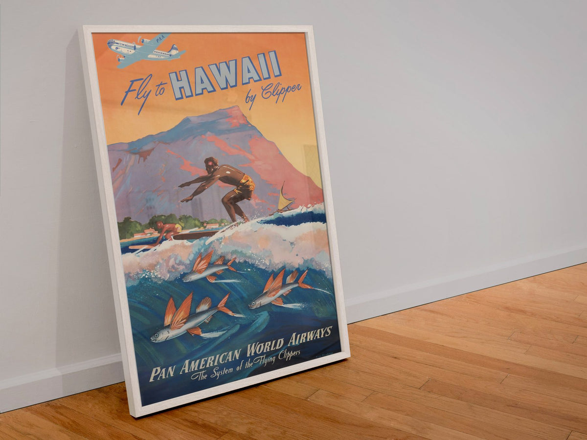 Fly to Hawaii by Clipper poster in a white frame leaning against a wall