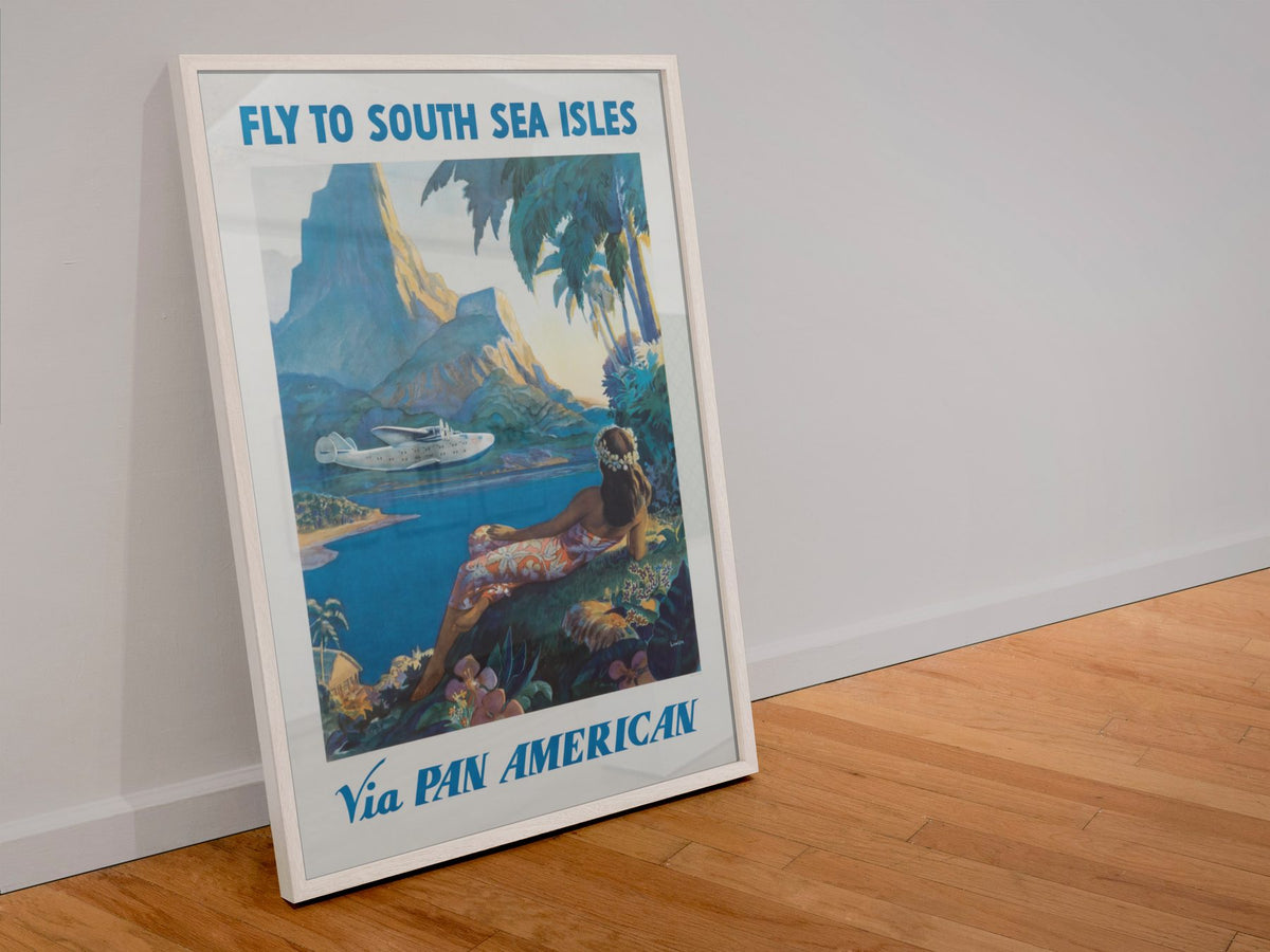 Fly to South Sea Isles Pan American poster in a white frame leaning against a wall