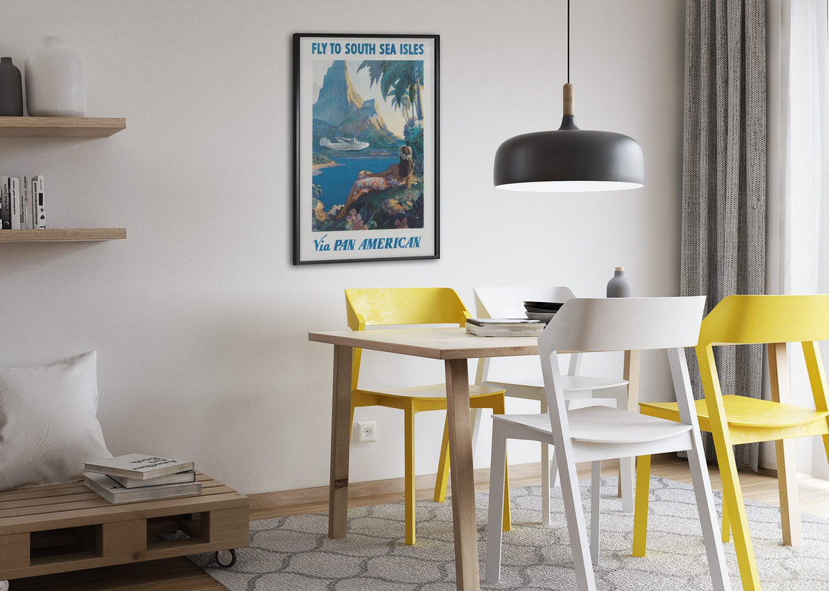 Fly to South Sea Isles Pan American poster framed above a dining table
