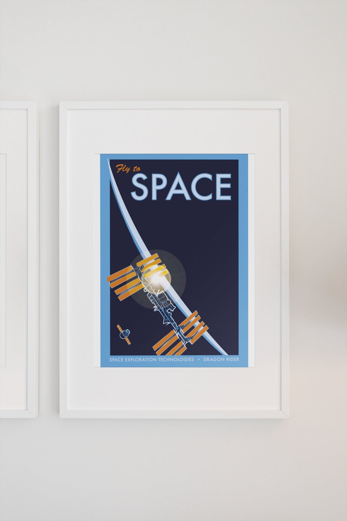 Fly to Space retro space travel poster in a white frame on a light wall