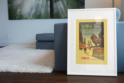 Fly TWA to Chicago Lion poster leaning beside a blue sofa
