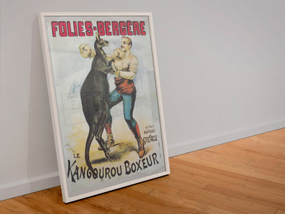 Folies-Bergère Kangaroo Boxer poster in a white frame leaning against a wall