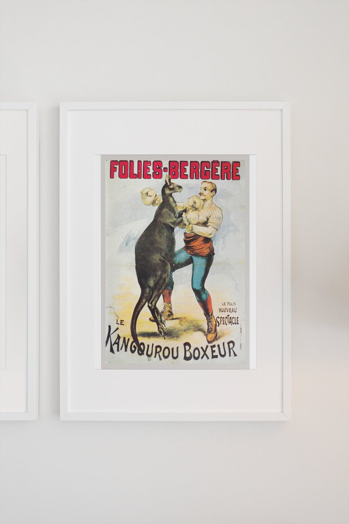 Folies-Bergère Kangaroo Boxer poster in a white frame on a light wall
