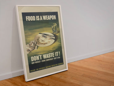 Food Is a Weapon Dont Waste It poster in a white frame leaning against a wall