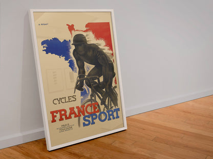 France Sport Cycles poster in a white frame leaning against a wall