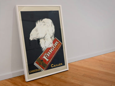 Frigor Chocolate Cailler Cappiello poster in a white frame leaning against a wall