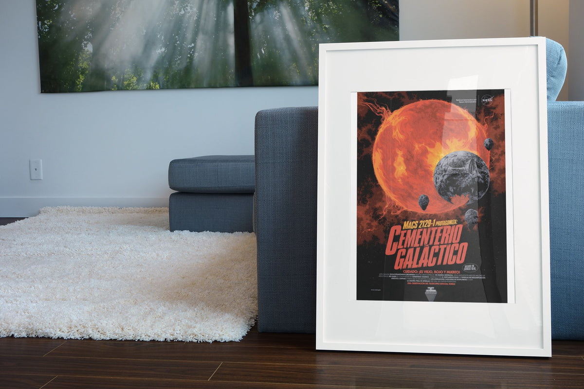 Galactic Graveyard, Cementerio Galáctico Spanish edition poster in a white frame leaning beside a blue sofa