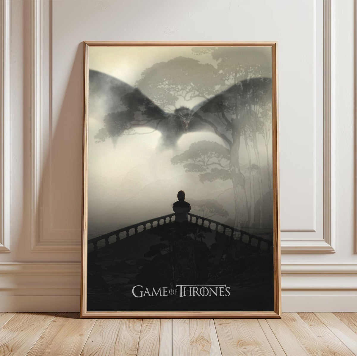 Game of Thrones Dragon Silhouette Art poster in a light oak frame leaning against a white wall