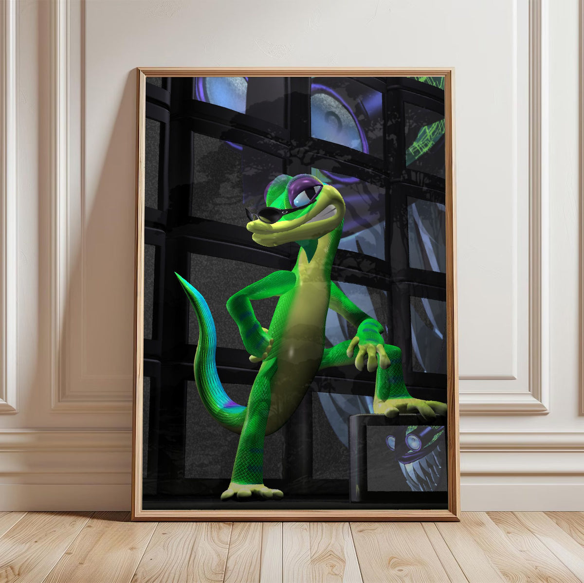 Gex: Enter the Gecko TV Wall Art poster in a light oak frame leaning against a white wall