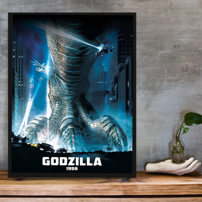 Godzilla (1998) Movie Key Art poster in a black frame on a wooden shelf against concrete