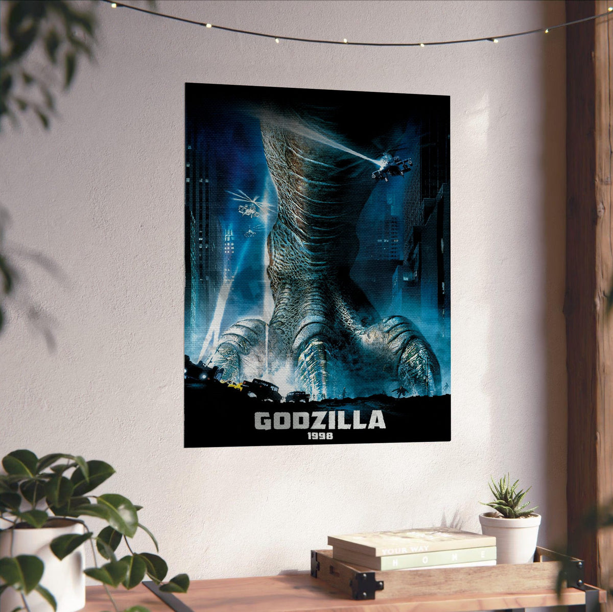 Godzilla (1998) Movie Key Art poster unframed on a white wall above a desk