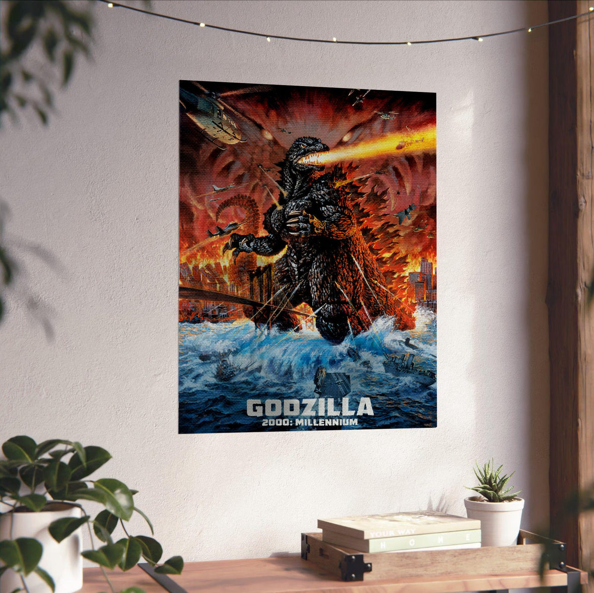 Godzilla 2000: Millennium (1999) Movie Key Art poster unframed on a white wall above a desk