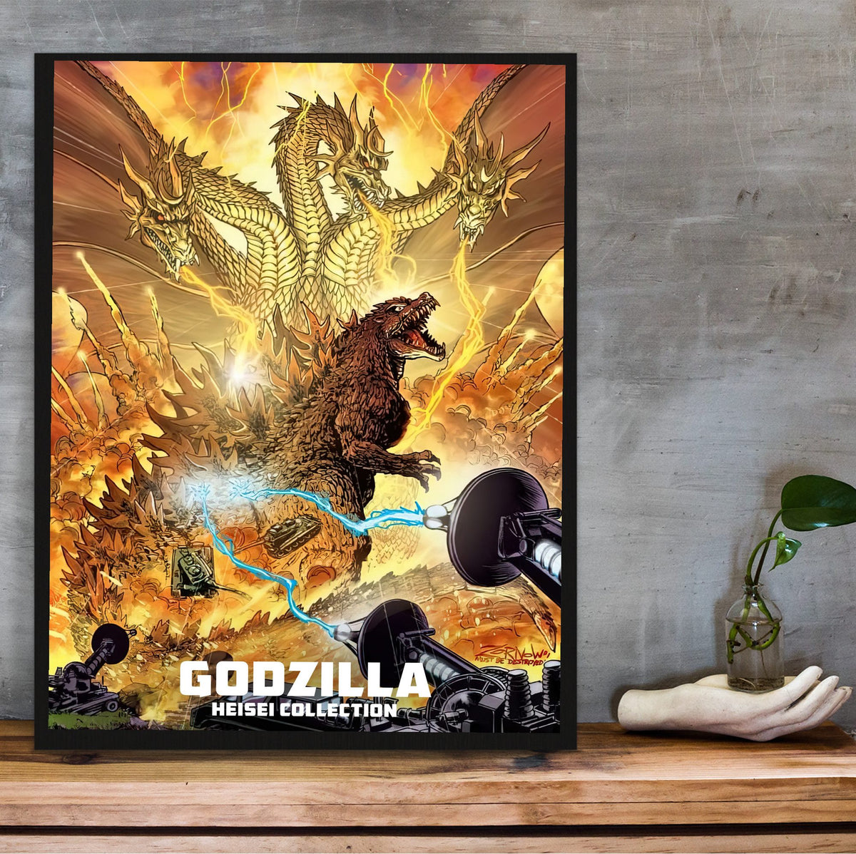 Godzilla Heisei Era Movie Collection Art poster in a black frame on a wooden shelf against concrete