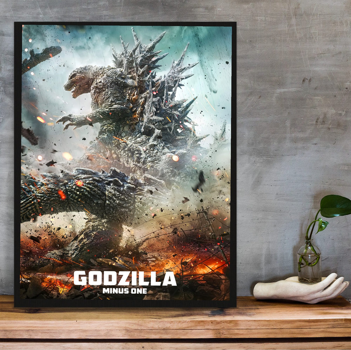 Godzilla Minus One (2023) Movie Key Art poster in a black frame on a wooden shelf against concrete