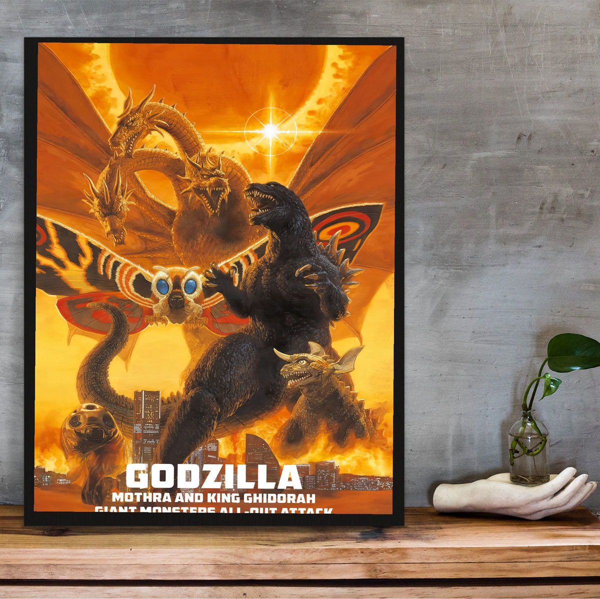 Godzilla, Mothra and King Ghidorah: Giant Monsters All-Out Attack (2001) Poster | Kaiju Wall Art Key Art poster in a black frame on a wooden shelf against concrete