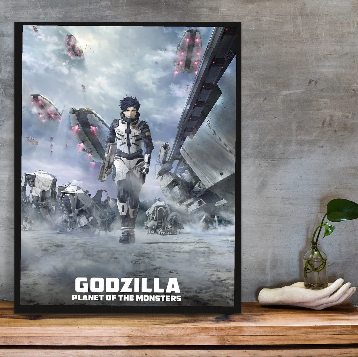 Godzilla: Planet of the Monsters (2017) Movie Key Art poster in a black frame on a wooden shelf against concrete
