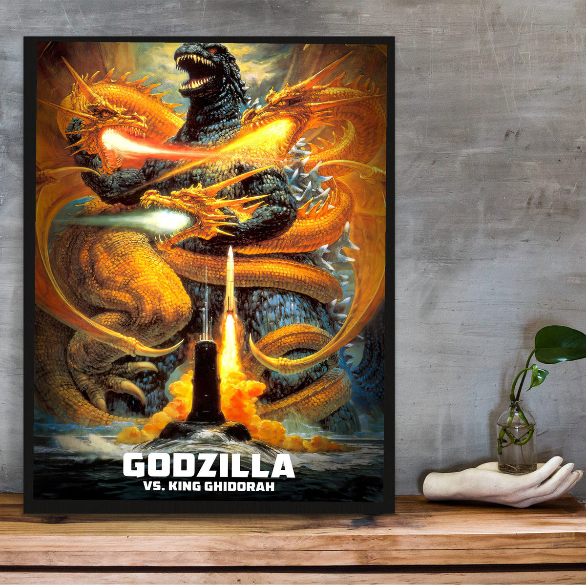 Godzilla vs. King Ghidorah (1991) Movie Key Art poster in a black frame on a wooden shelf against concrete
