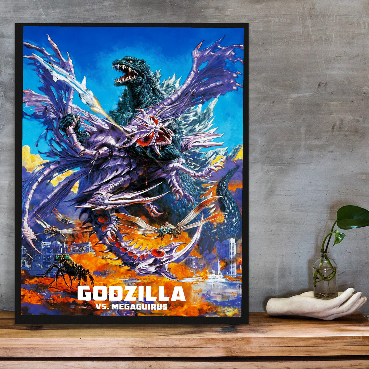 Godzilla vs. Megaguirus (2000) Movie Key Art poster in a black frame on a wooden shelf against concrete