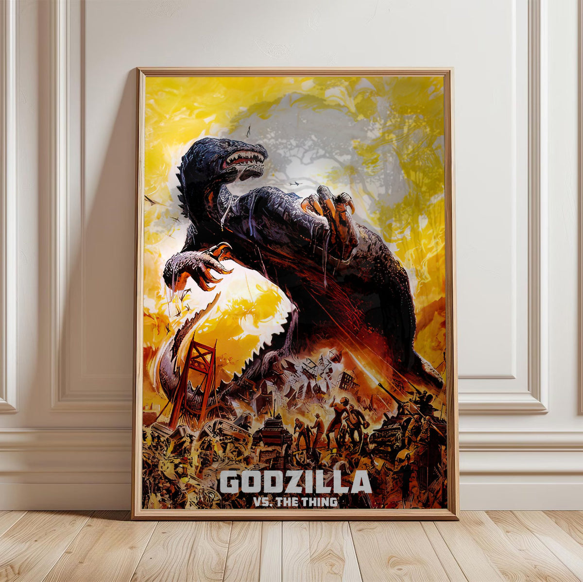 Godzilla vs. The Thing (1964) Movie Illustrated Art poster in a light oak frame leaning against a white wall