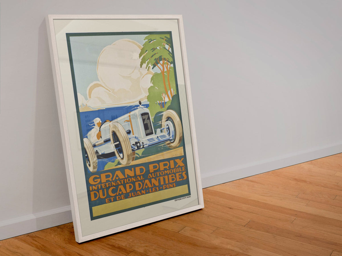 Grand Prix du Cap d'Antibes et de Juan-les-Pins poster in a white frame leaning against a wall