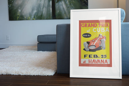Grand Prix of Cuba Havana poster in a white frame leaning beside a blue sofa