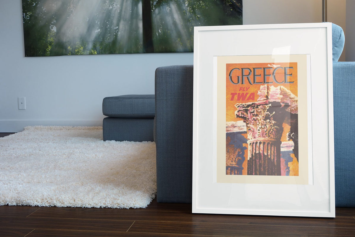Greece Fly TWA 1960s poster leaning beside a blue sofa