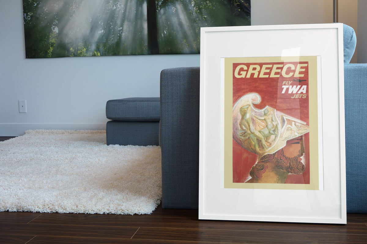 Greece Fly TWA Jets poster leaning beside a blue sofa