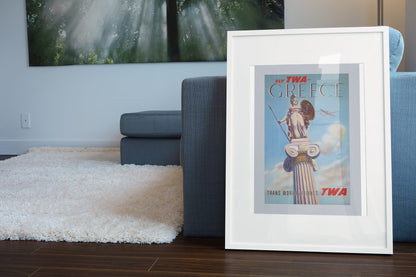 Greece Fly TWA 1955 poster leaning beside a blue sofa