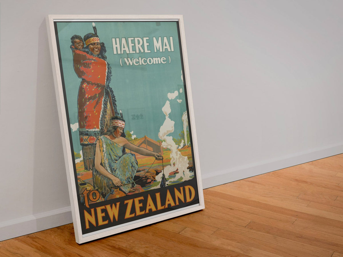 Haere Mai Welcome to New Zealand poster in a white frame leaning against a wall