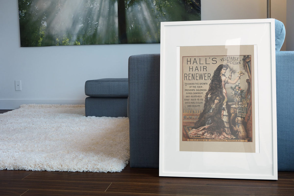 Halls Hair Renewer poster leaning beside a blue sofa