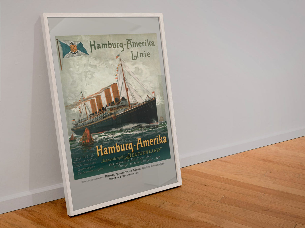 Hamburg Amerika Linie 1900 poster in a white frame leaning against a wall