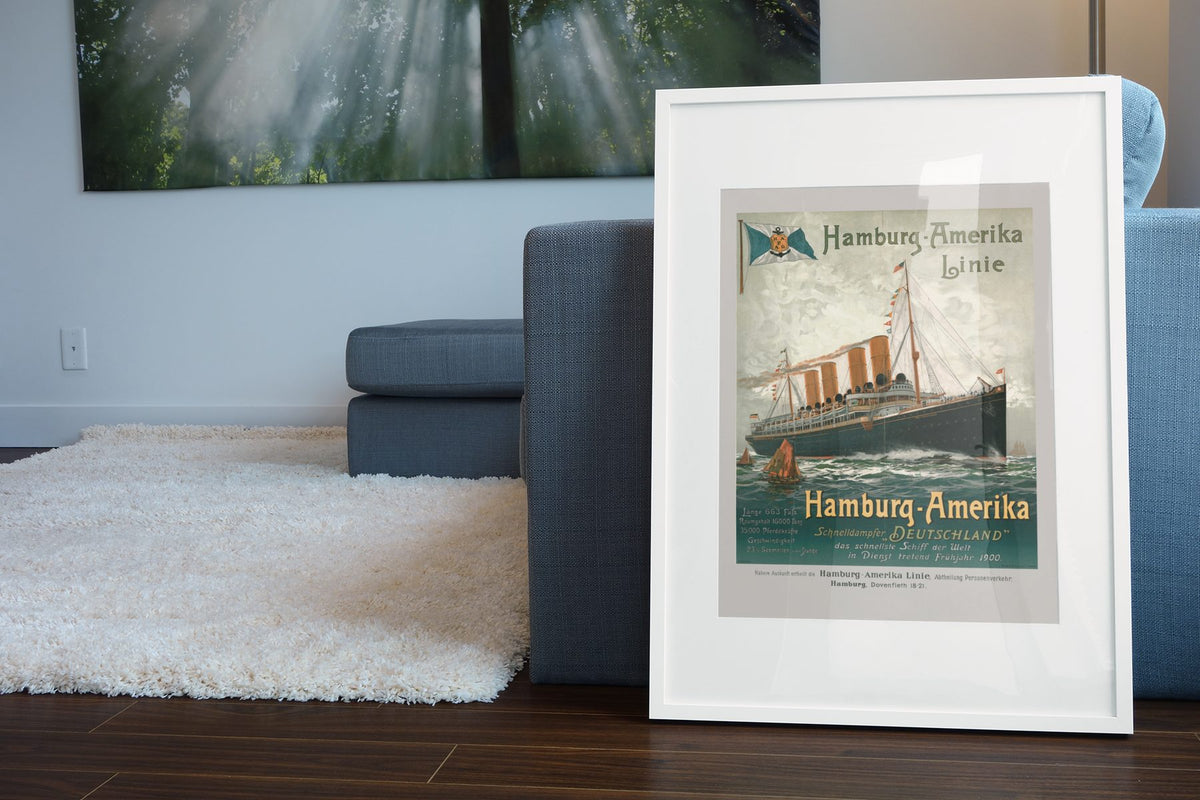 Hamburg Amerika Linie 1900 poster leaning beside a blue sofa