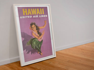 Hawaii Hula United Air Lines poster in a white frame leaning against a wall