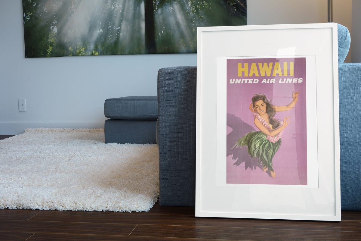 Hawaii Hula United Air Lines poster leaning beside a blue sofa
