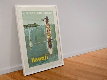 Hawaii Outrigger Canoe poster in a white frame leaning against a wall
