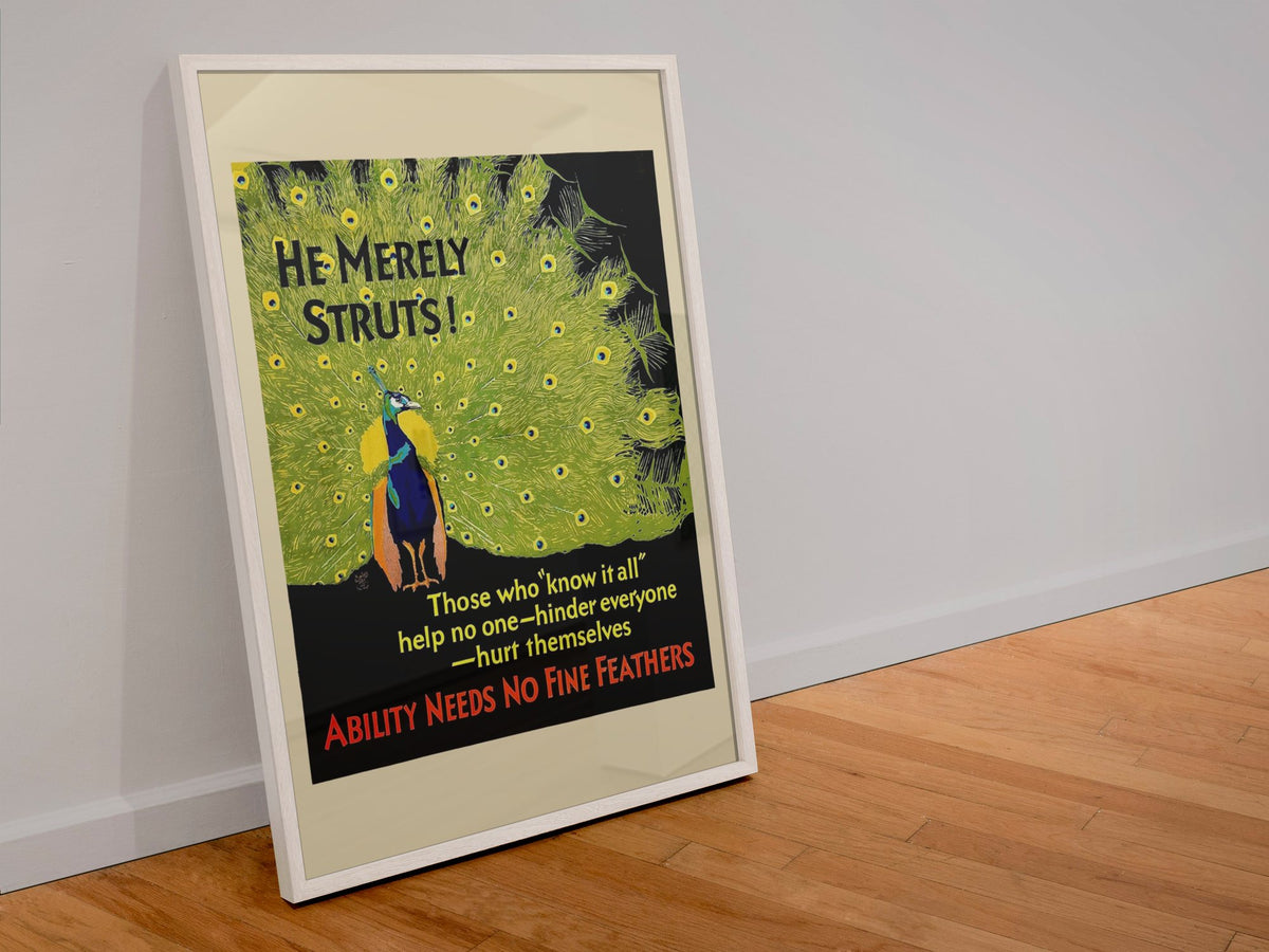 He Merely Struts poster in a white frame leaning against a wall