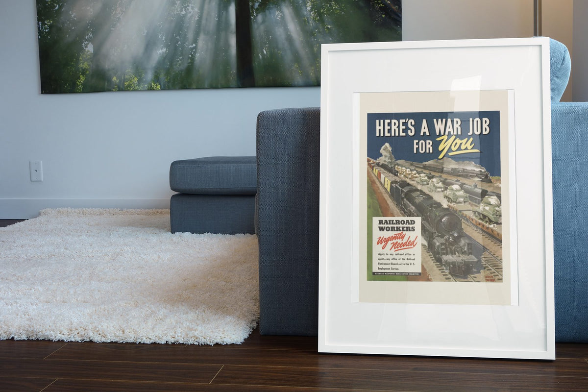 Heres a War Job for You Railroad Workers poster leaning beside a blue sofa