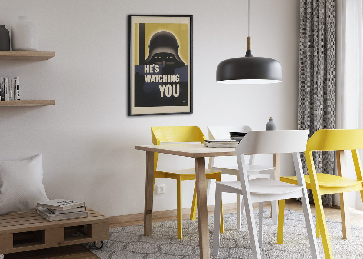 Hes Watching You poster framed above a dining table