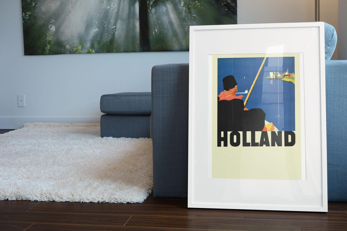 Holland poster leaning beside a blue sofa