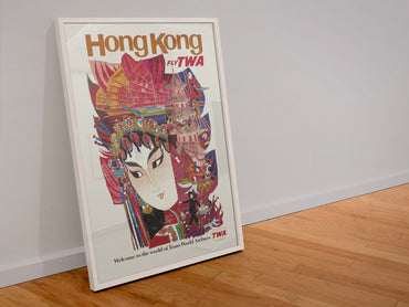 Hong Kong Fly TWA poster in a white frame leaning against a wall