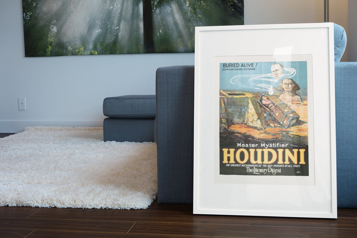 Houdini Buried Alive Egyptian Sphinx poster leaning beside a blue sofa