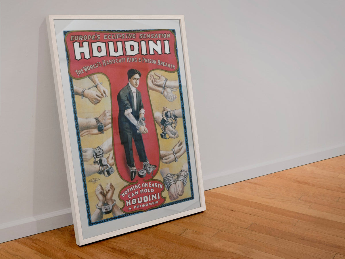 Houdini Handcuff King poster in a white frame leaning against a wall