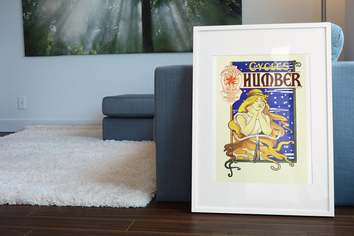 Humber Cycles poster leaning beside a blue sofa