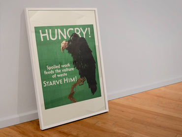 Hungry poster in a white frame leaning against a wall