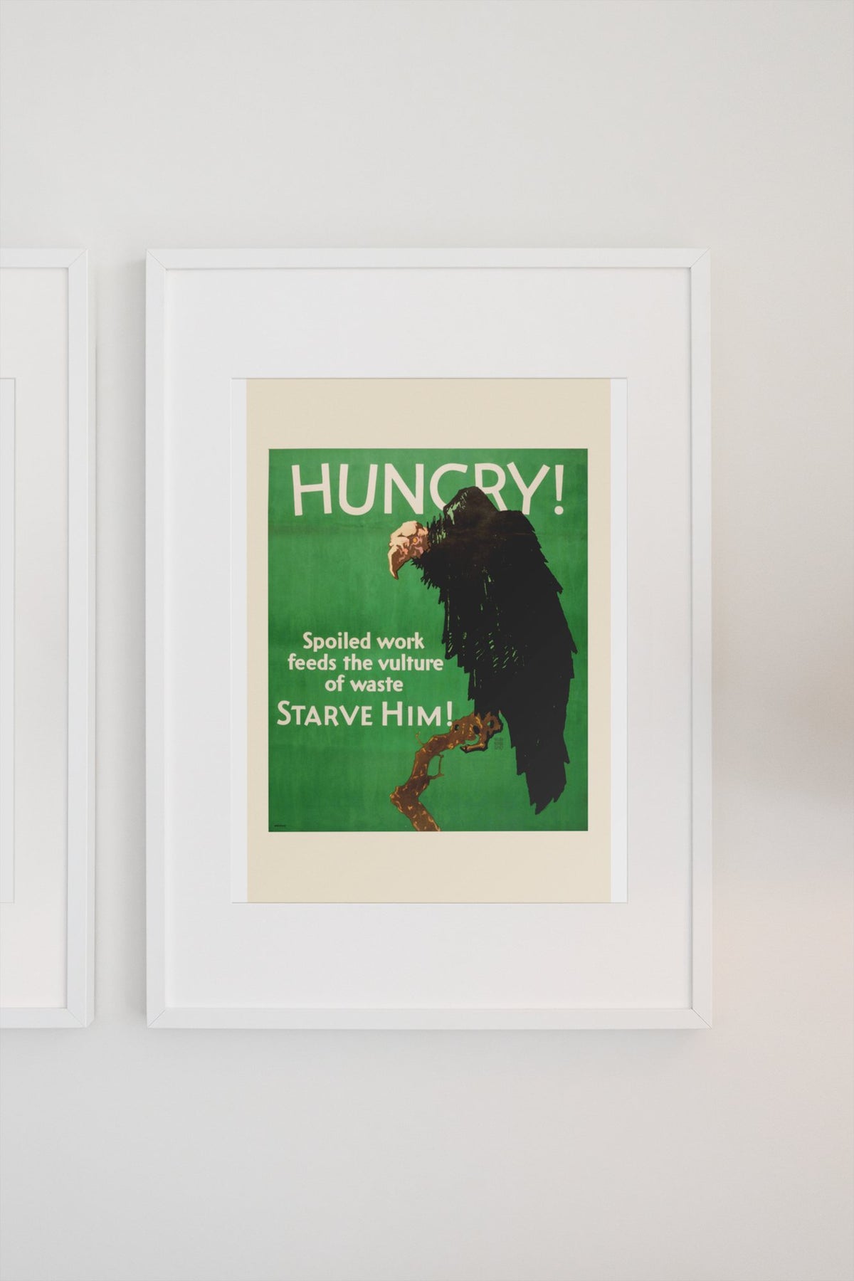Hungry poster in a white frame on a light wall
