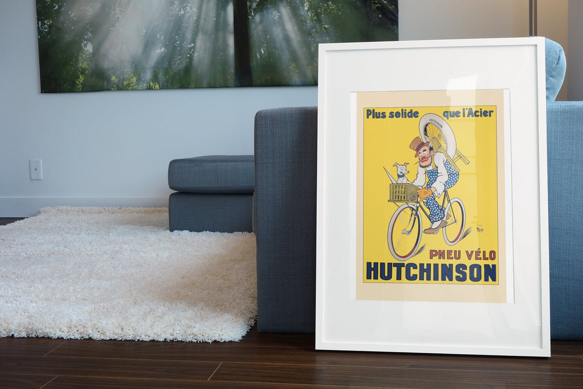 Hutchinson Pneu Velo poster leaning beside a blue sofa