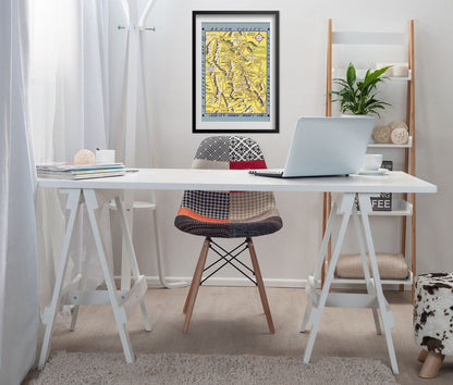 Hysterical Map of Death Valley 1940s print framed above a white desk in a home office